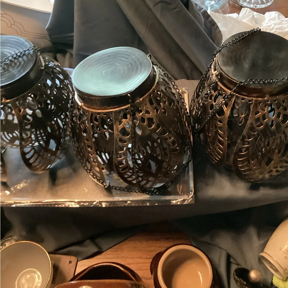 3 ornate tree lanterns outside